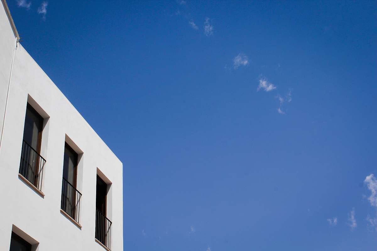 home decor white concrete building under blue sky window